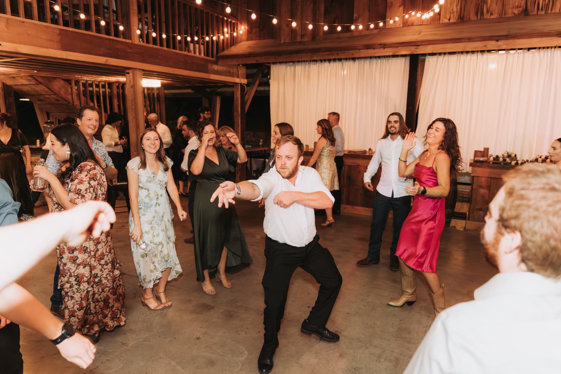 Wedding guest dancing in the middle of the floor as the crowd cheers